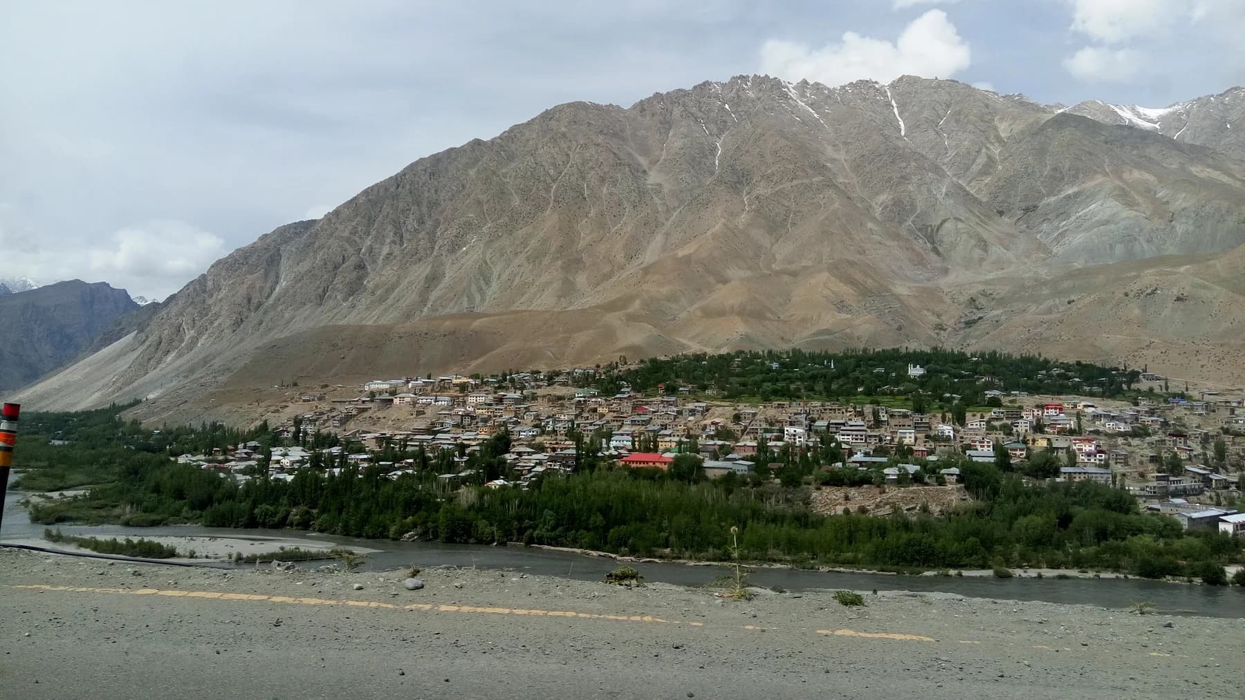 Kargil town beside a river beneath rugged mountains